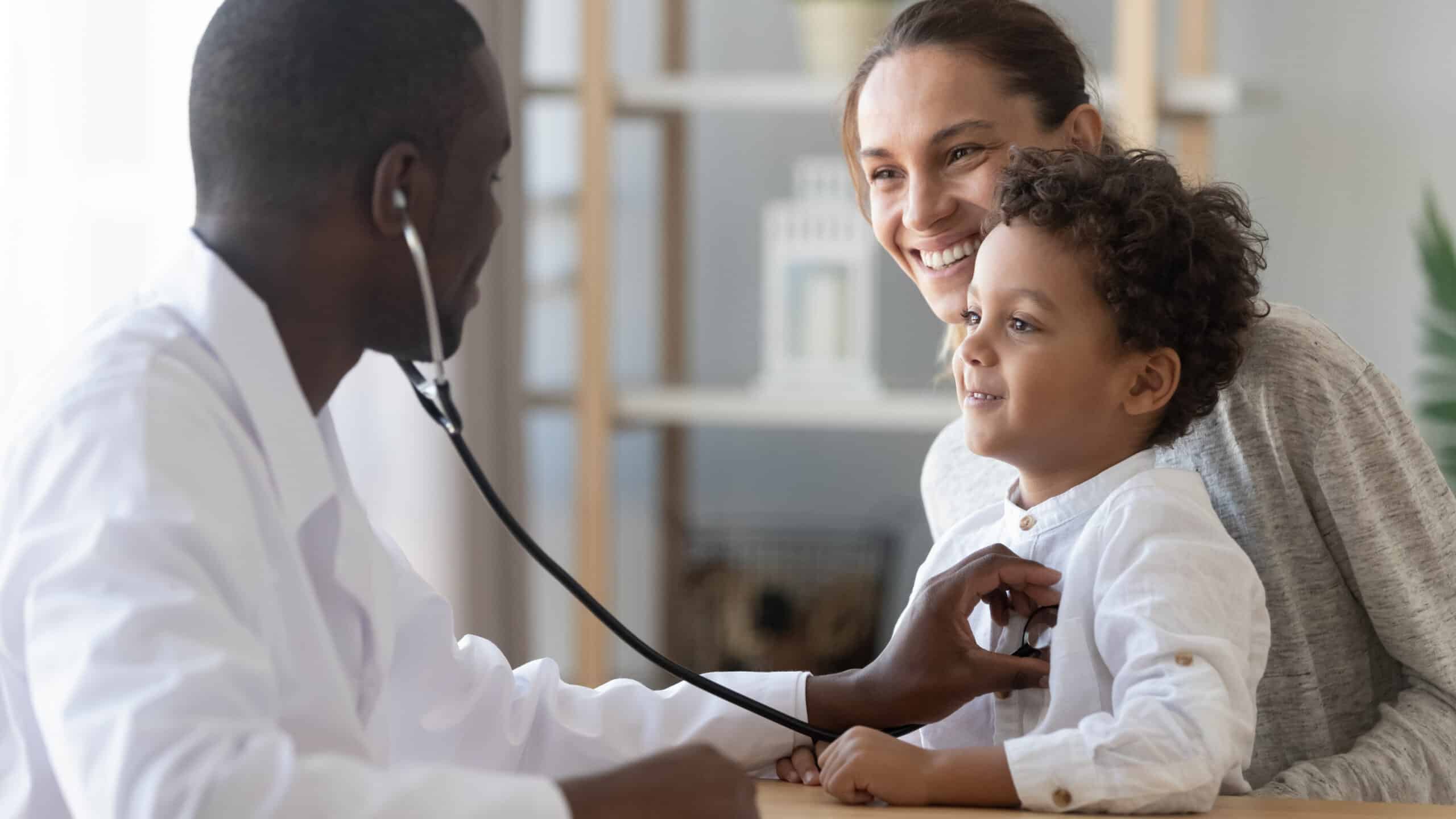 A doctor doing a health check-up on a child with their mother