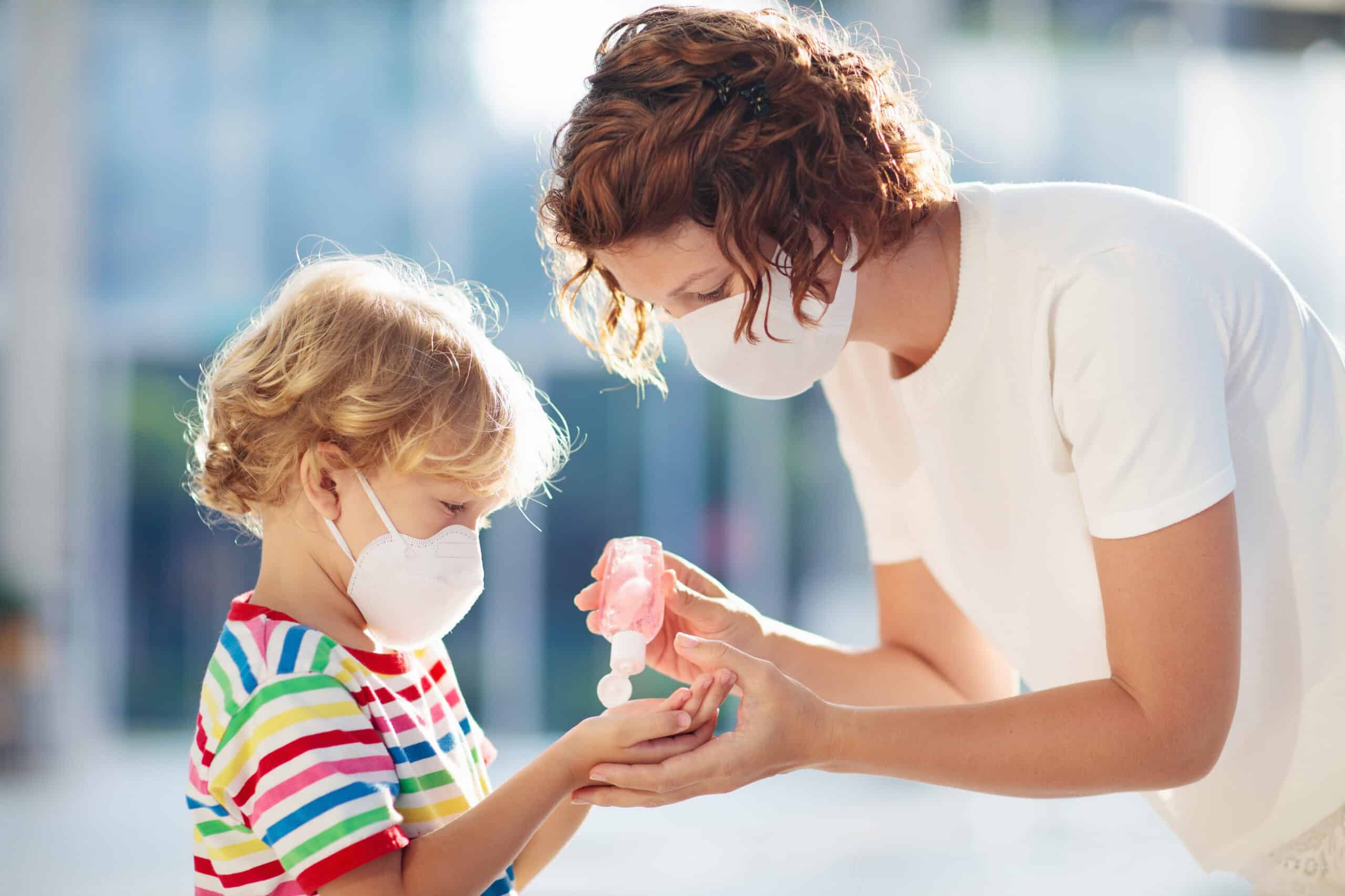 A mum giving her child hand gel