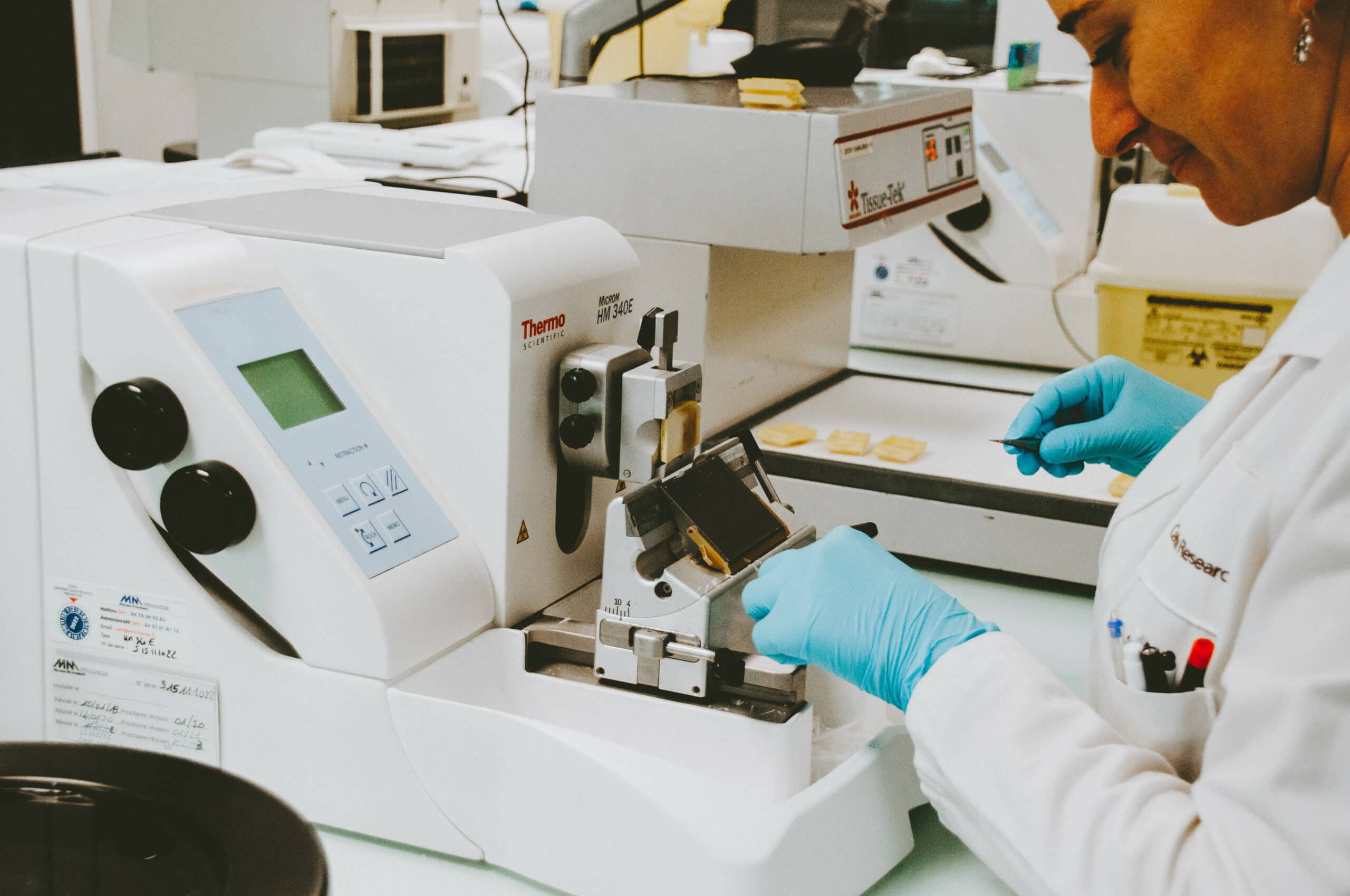 Researcher using a machine to analyze a sample